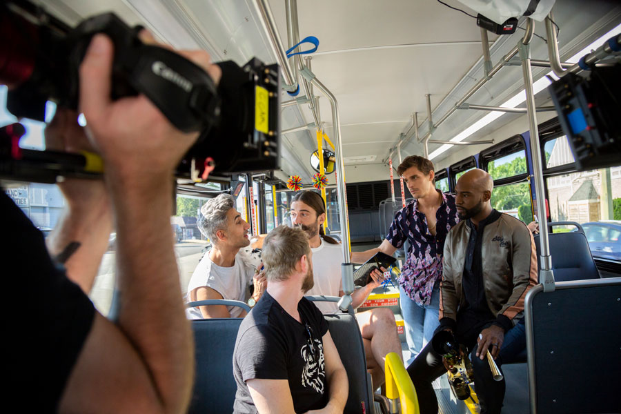 On a RideKC bus, a camera films the cast of the television show Queer Eye. 