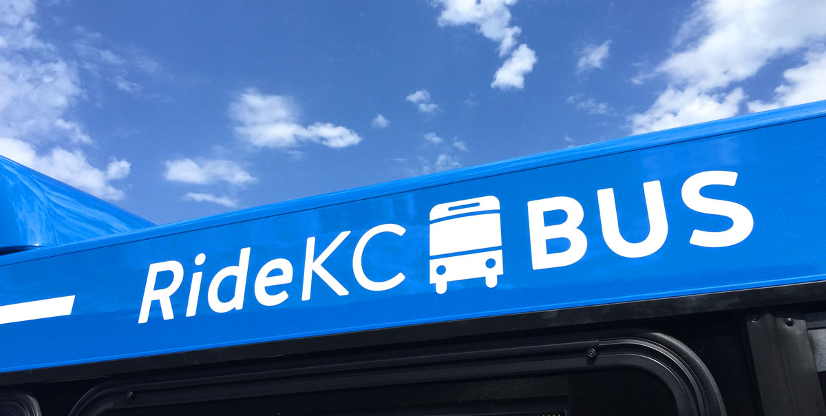 RideKC logo on bus with partly cloudy sky in the background