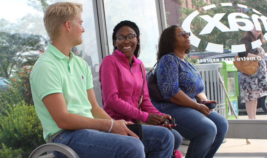 Riders talking at bus stop